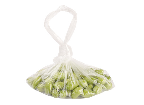 Green olives in a transparent plastic bag (Clipping Path) isolated on the white background