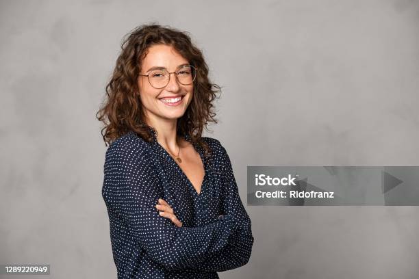 Successful Smiling Woman Wearing Eyeglasses On Grey Wall Stock Photo - Download Image Now