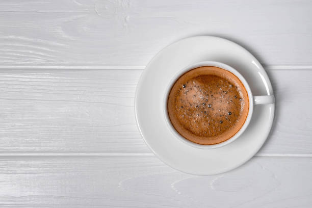 istock Cup of coffee and saucer on white background. 1289222428