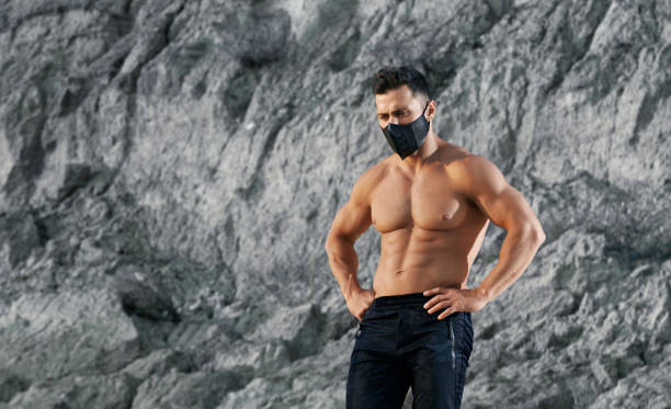 istock Powerful man in protective mask posing outdoors 1289222609