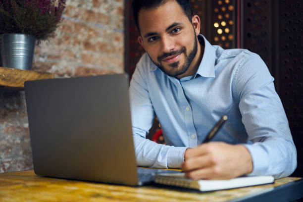 istock Positive male freelancer working at table 1289223705