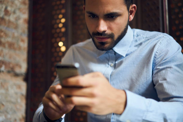 istock Serious male entrepreneur browsing smartphone 1289223710