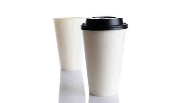 istock White paper cup for hot coffee with black lid isolated on white background. Takeaway blank small tea cup for your design text or banner of brand. 1289223727