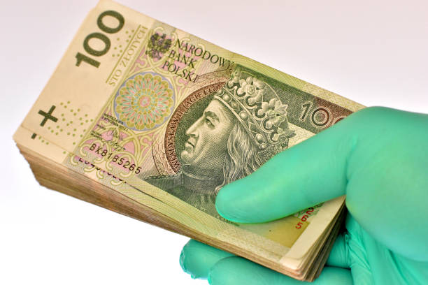 istock Hand in latex glove holds Polish banknotes 1289224917