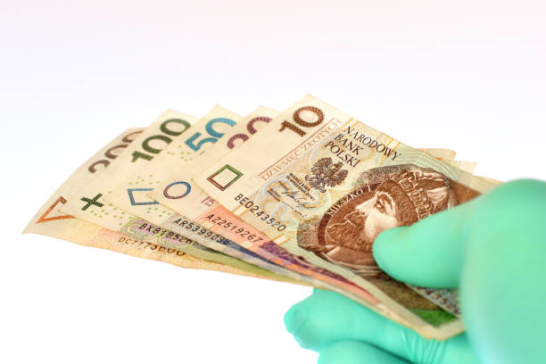 istock Hand in latex glove holds Polish banknotes 1289225185