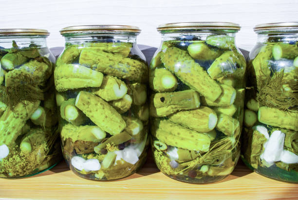 istock Jars of pickled cucumbers on table 1289225308