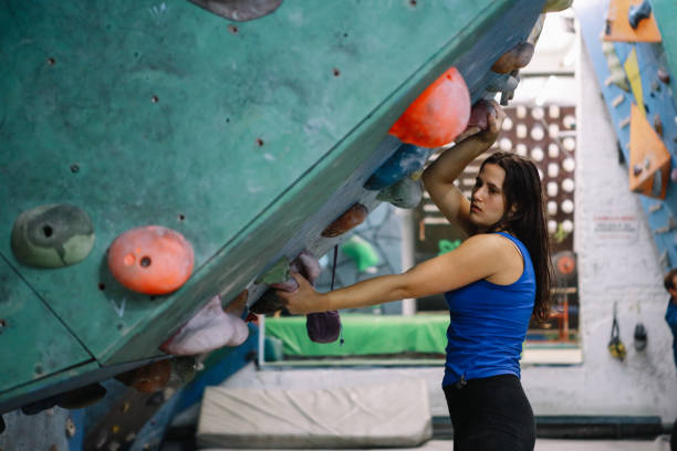 istock Young woman training boulder climbing 1289226327