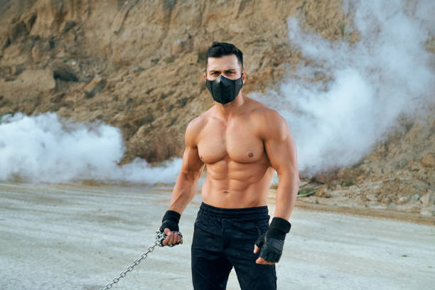 istock Handsome man with athletic body posing outdoors 1289226455