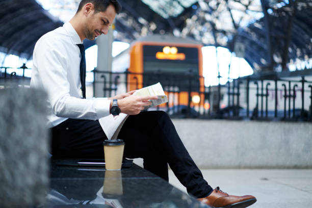 istock Confident man resting with newspaper on street 1289226549