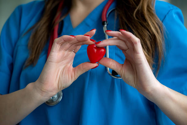 istock Female doctor holding small red heart 1289226551