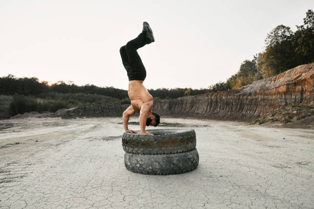istock Shirtless man using heavy tyres for sport activity 1289226857