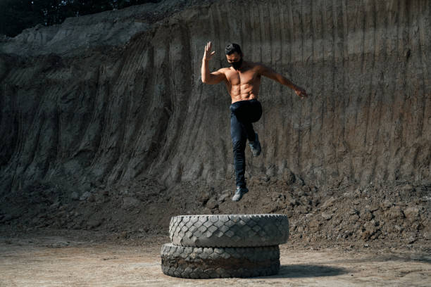 istock Powerful man with muscular body training legs outdoors 1289227661