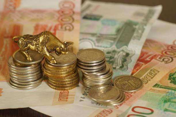 istock Metal bull with paper bills on the table. 1289227879
