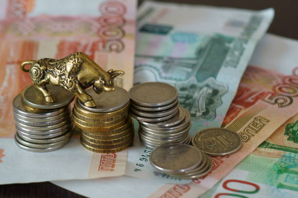 istock Metal bull with paper bills on the table. 1289227951
