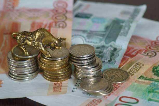 istock Metal bull with paper bills on the table. 1289227974