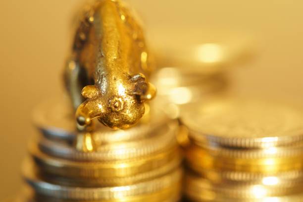istock Metal bull with coins on the table. 1289228051