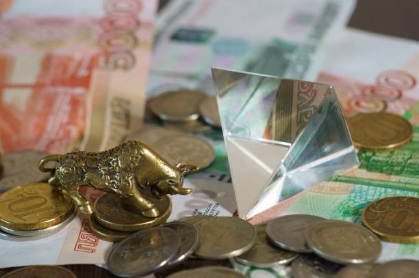 istock Metal bull with paper bills on the table. 1289228059