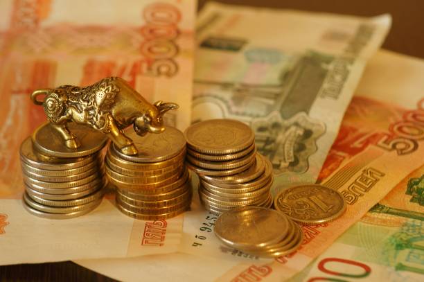 istock Metal bull with paper bills on the table. 1289228072