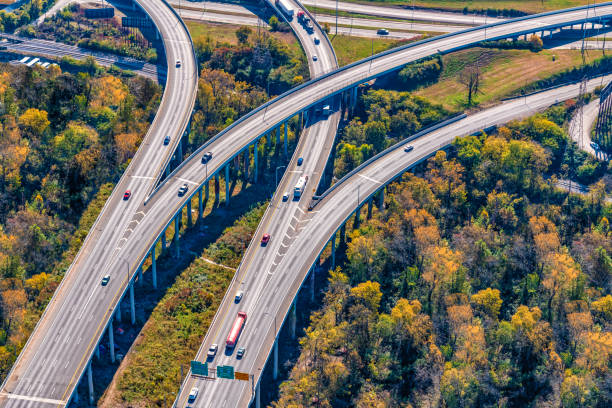 Freeway Merge Aerial Composite image of separate east and westbound elevated interstate roadways splitting and merging into another north/south freeway shot aerially from about 1000 feet in altitude. This shot taken just outside of downtown Nashville, Tennessee. nashville tennessee bridge stock pictures, royalty-free photos & images