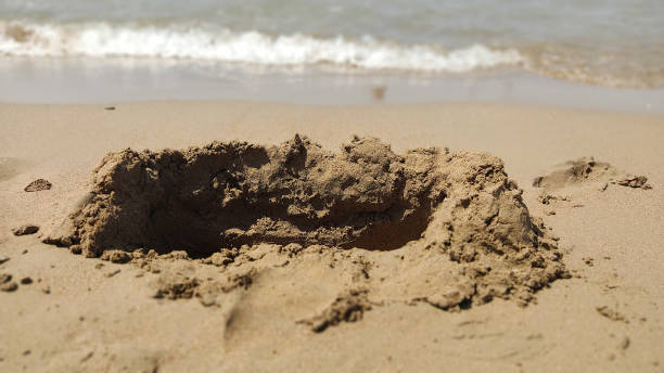 istock destructive wave castle on the sand by the sea 1289229775