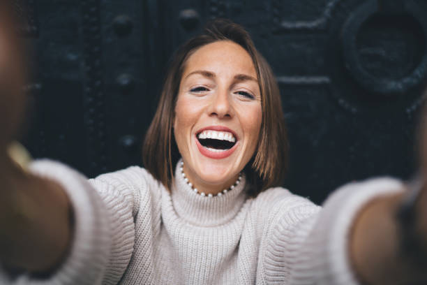 istock Happy woman taking selfie on smartphone 1289230938