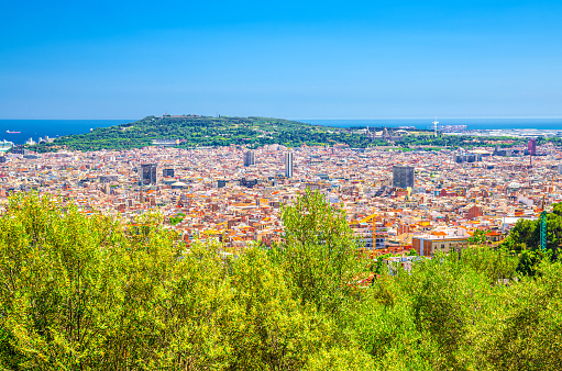 Aerial panoramic view of Barcelona city historical quarters districts with Montju c hill, Mediterranean Sea