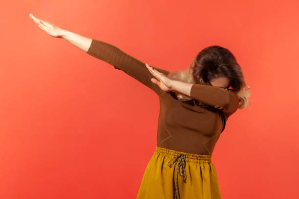 istock Young woman raising hands in dab dance 1289236051