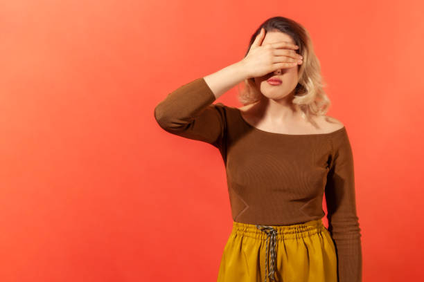 istock Woman closing her eyes with her palm 1289236124