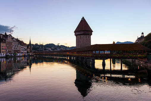 Lucerne's tourist attraction is the Chapel Bridge, a medieval covered wooden bridge that connects the banks of the Reuss River, which comes from Lake Lucerne. city of Lucerne, Switzerland, Europe