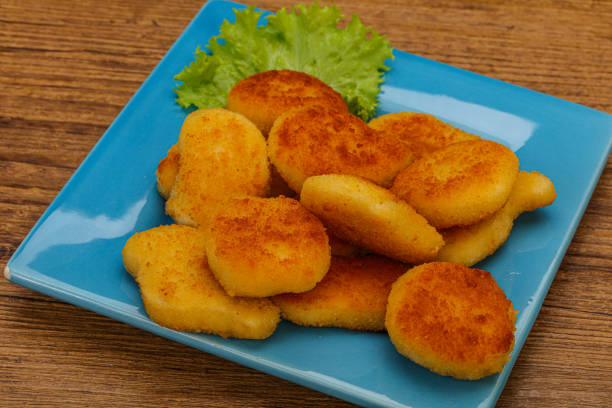 istock Fried chicken nuggets served salad leaves 1289239924