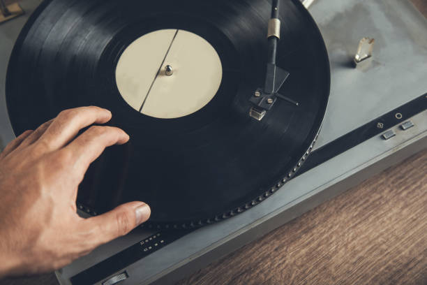 istock hands turning on vintage gramophone 1289241022