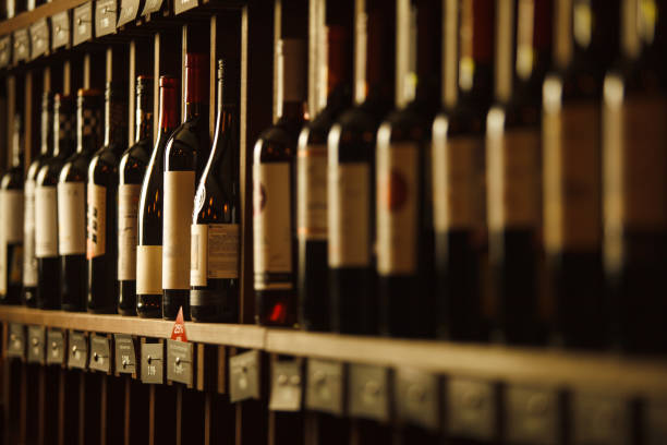 istock Wine cellar with elite drinks on shelves with written names 1289241256