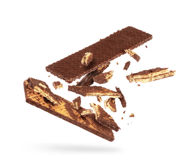 istock Chocolate waffle is breaking into many pieces in the air on a white background 1289241566
