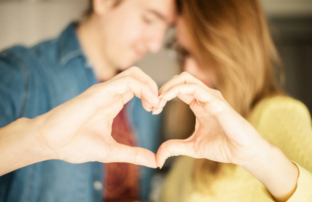 istock Couple holding hands in heart shape. 1289243722