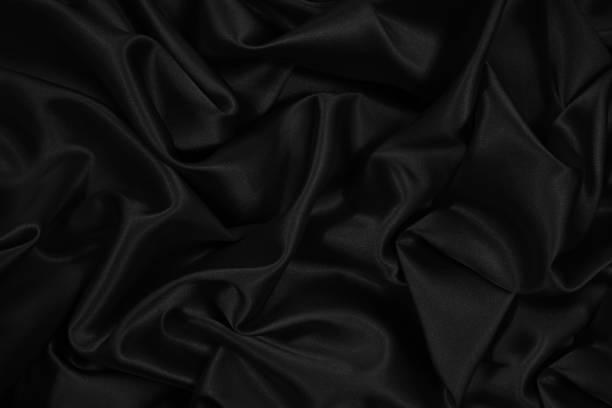 istock Black silk satin. Black elegant shiny fabric background. Beautiful abstract background. 1289244069