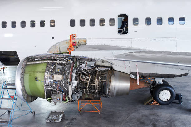 istock aircraft engine servicing - opened panels of a large engine of parked aircraft. 1289244254