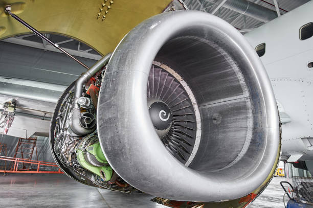 istock aircraft engine servicing - opened panels of a large engine of parked aircraft. 1289244256