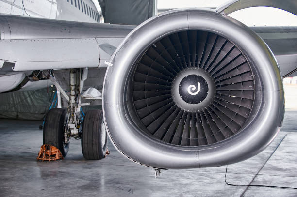istock aircraft engine servicing - opened panels of a large engine of parked aircraft. 1289244265