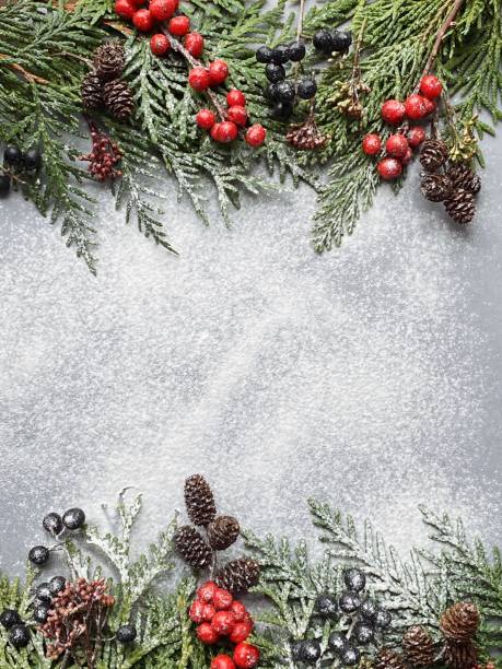 istock Christmas tree branches with  on a flour wall background. Template for greeting card or design. Vertical banner with copy space 1289245365
