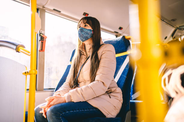 istock Woman with protective face mask traveling by public transportation 1289247955