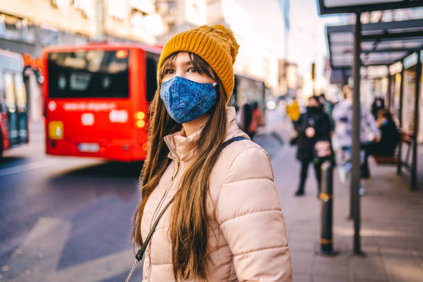 istock Woman with protective mask waiting for the bus 1289248021