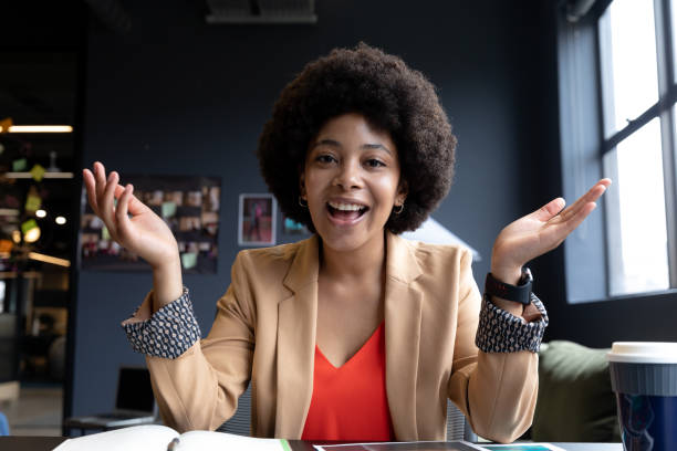 istock Mixed race businesswoman during video call in creative office, talking 1289248574