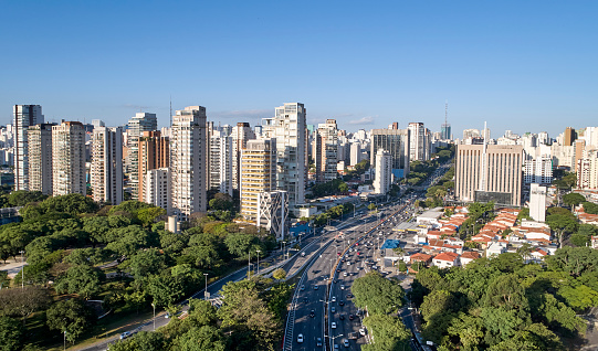 Aerial view of Sao Paulo city, car traffic in 23 de Maio avenue, north-south corridor, commercial and residential buildings in Sao Paulo city,  Brazil.
