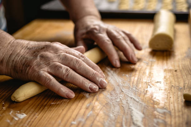 istock Senior woman is rolling pastry dough by hand 1289249747