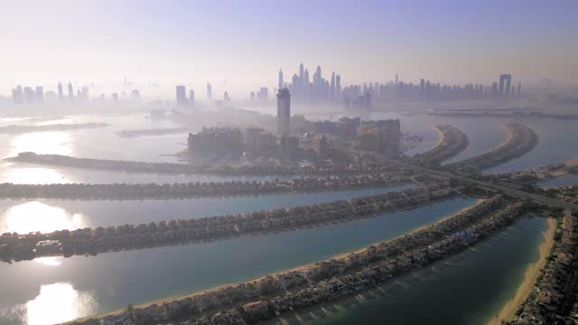 The Palm island in Dubai United Arab Emirates aerial view at sunrise. Famous artificial island with luxury villas and hotels