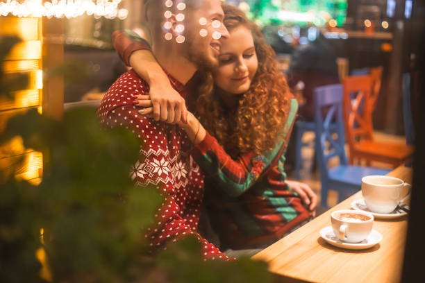 istock Loving couple in a cafe hug and drink cocoa 1289249971
