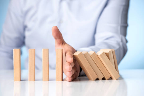 istock Risk Management and Insurance Concept. Businessman Stop Domino Effect. 1289251085
