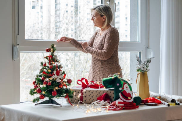 istock Senior woman wrapping presents 1289252174