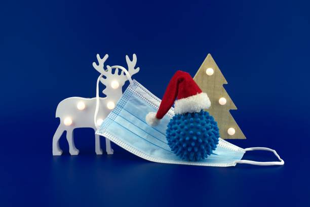istock Christmas deer scene with coronavirus gift 1289252323