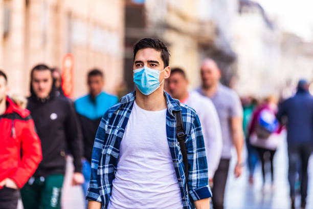 istock Man wearing a mask on the street 1289252604